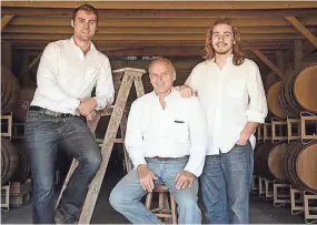  ?? COURTESY OF LIZ HENRY ?? Joe Henry (center) and sons Joe (left) and Jack in the ricking room on their Dane farm, where the bourbon is aged.