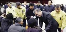  ?? - Yonhap via Reuters ?? CONSOLING: South Korean President Moon Jae-in comforts a relative of a victim of a hospital blaze at a memorial altar for the victims in Miryang, South Korea, on January 27, 2018.