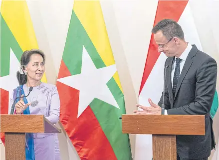  ?? AP ?? Myanmar’s State Counsellor Aung San Suu Kyi, left, speaks during a press conference with Hungarian Minister of Foreign Affairs and Trade Peter Szijjarto in Budapest on June 5.