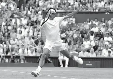  ?? Associated Press ?? Switzerlan­d's Roger Federer returns to Germany's Mischa Zverev during their match on day six Saturday at Wimbledon in London.