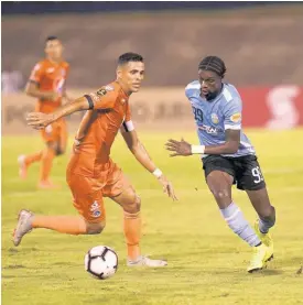  ??  ?? FC Motagua player Marcelo Pereia gets turned by Waterhouse’s Colorado Murray in their Concacaf League match at the National Stadium on Wednesday, September 26, 2019.