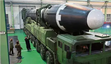  ?? — AP ?? New toy: Kim checking out the Hwasong-15 ICBM at an undisclose­d location.