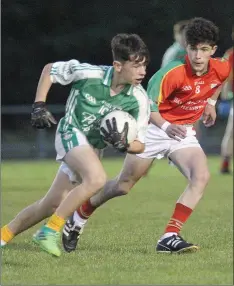  ??  ?? Naomh Eanna’s Kyle Kenny looks to take on Matt Kinnaird of the Starlights in their clash at St Patrick’s Park.