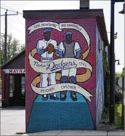  ?? CHARLES KRUPA/AP ?? A mural honors Nashua Dodgers greats Don Newcombe and Roy Campanella in Nashua, New Hampshire. Holman Stadium is being recognized for hosting the country’s first racially integrated baseball team, the Nashua Dodgers, in 1946. The club was a minor league affiliate of the Brooklyn Dodgers.