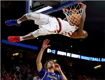  ?? JOHN PETERSON — THE ASSOCIATED PRESS ?? Iowa State’s Keshon Gilbert dunks as South Dakota State’s Zeke Mayo, bottom, watches during the first half of a first-round college basketball game in the NCAA Tournament Thursday, March 21, 2024, in Omaha, Neb.