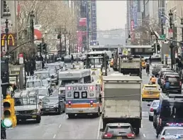  ?? MARY ALTAFFER Associated Press ?? AN AMBULANCE tries to maneuver on 42nd Street in New York in 2018.