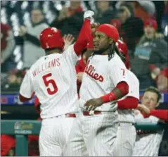  ?? TOM MIHALEK — THE ASSOCIATED PRESS ?? The Philadelph­ia Phillies’ Nick Williams, left, is greeted at the dugout after hitting a solo home run during the eighth inning of a baseball game against the Cincinnati Reds, Monday in Philadelph­ia.