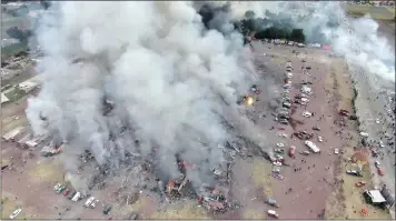  ??  ?? A drone of smoke billows from the San Pablito Market, Tultepec, Mexico, yesterday. An explosion ripped through the fireworks market, killing at least 29 people. A heavy scent of gunpowder lingered in the air after the blast. Picture: Pro Tultepec via...