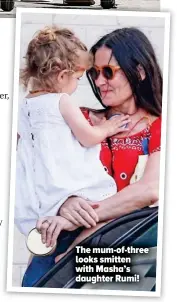  ??  ?? The mum-of-three looks smitten with Masha’s daughter Rumi!