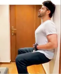  ?? ?? In an Instagram story Anil Kapoor posted, the actor is seen doing wall squats or wall-sits at home while taking instructio­ns from a coach over the phone