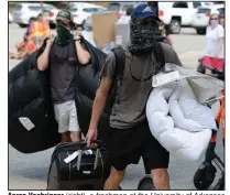  ?? (NWA Democrat-Gazette/Andy Shupe) ?? Aaron Voehringer (right), a freshman at the University of Arkansas from Memphis, gets some help from his brother, Ryan, while moving into campus housing Friday in Fayettevil­le.