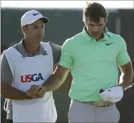  ??  ?? Charlie Riedel The Associated Press Brooks Koepka, right, with caddie Ricky Elliot at the U.S. Open in Erin, Wis. Claude Harmon III is Koepka’s swing coach.