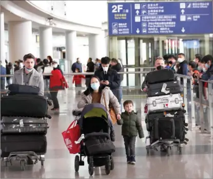  ?? ZOU HONG / CHINA DAILY ?? Travelers exit Beijing Capital Internatio­nal Airport’s Terminal 3 on Jan 8 after it reopened for internatio­nal arrivals. Under China’s optimized COVID policy, passengers arriving on the mainland are no longer required to undergo quarantine and nucleic acid tests.