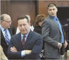  ?? HERALD POOL PHOTO ?? NO VERDICT YET: Aaron Hernandez, right, stands as his attorneys confer at Suffolk Superior Court yesterday.