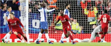  ?? — Reuters photo ?? Liverpool’s Naby Keita (centre) celebrates with midfielder Roberto Firmino scoring their first goal during the UEFA Champions League quarter-final, first leg match against FC Porto at Anfield stadium in Liverpool, north-west England.