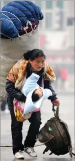  ?? PHOTOS BY ZHOU KE / XINHUA ?? In a moment that touched the hearts of millions, Bamuyubumu (left), a young migrant worker, struggles to balance oversized luggage on her back and a baby in her arm near a railway station in Nanchang, Jiangxi province, on Jan 30, 2010. The photo portraying hardship contrasts with Bamuyubumu’s life today. She sits with her children (right) in front of their home in Taoyuan village in Sichuan province on Jan 22 this year.