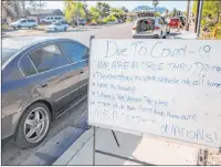  ??  ?? A line of cars waiting at St. Therese Center HIV Outreach in Henderson stretches a mile down Palo Verde Drive on Tuesday morning. CCSD has shifted hours at its food distributi­on sites.