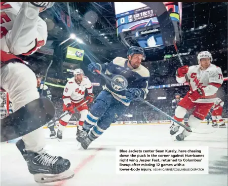  ?? ADAM CAIRNS/COLUMBUS DISPATCH ?? Blue Jackets center Sean Kuraly, here chasing down the puck in the corner against Hurricanes right wing Jesper Fast, returned to Columbus' lineup after missing 12 games with a lower-body injury.