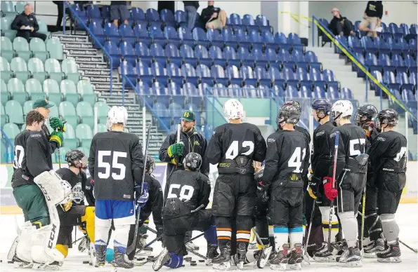  ?? PHOTOS: LIAM RICHARDS ?? Humboldt Bronco hopefuls listen to new head coach Nathan Oystrick as the team opened training camp at Elgar Petersen Arena.