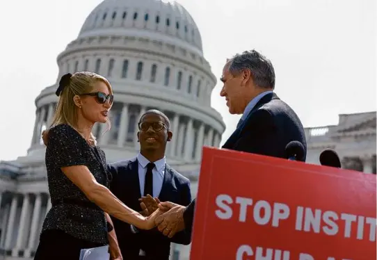  ?? ANNA MONEYMAKER/GETTY IMAGES ?? BILL SUPPORT — Actress and model Paris Hilton shook hands with Senator Jeff Merkley, Democrat of Oregon, outside the US Capitol Building Thursday. Hilton joined lawmakers to introduce the bipartisan, bicameral bill “Stop Institutio­nal Child Abuse Act” which would provide more oversight for institutio­nal youth treatment programs.