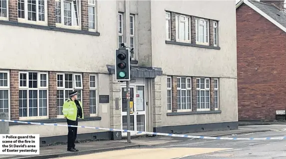  ??  ?? Police guard the scene of the fire in the St David’s area of Exeter yesterday