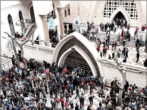  ?? AP/NARIMAN EL-MOFTY ?? Onlookers and victims’ relatives gather outside a church after a fatal bomb attack Sunday in the Nile Delta town of Tanta, Egypt.