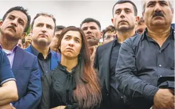  ?? Oscillosco­pe Laboratori­es ?? NADIA MURAD and fellow activists attend a rally honoring Yazidi victims in 2016 in “On Her Shoulders.” She has since won the Nobel Peace Prize.