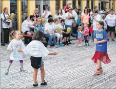  ?? ADAM MACINNIS/THE NEWS ?? Some children enjoyed dancing to the sound of music outside the deCoste Entertainm­ent Centre on Saturday at a Light the Night event in Pictou.