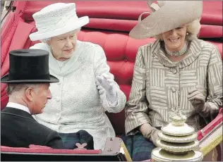  ?? MATTHEW LLOYD/ AP ?? Queen Elizabeth travels by carriage to Buckingham Palace with Camilla, the Duchess of Cornwall and Prince Charles, after a lunch at Westminste­r Hall in London on Tuesday.