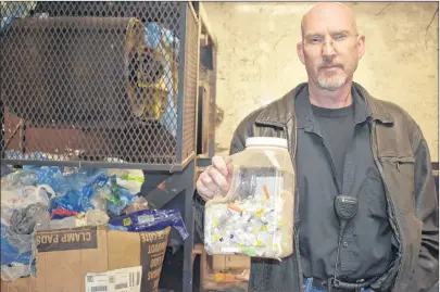  ?? NIKKI SULLIVAN/CAPE BRETON POST ?? Jeff Strong, operations supervisor at Camdon Recycling in Sydport, holds a bottle of needles and lancets staff have found recently while sorting through materials. He said there has been a problem with needles in recycling bags since the program started.