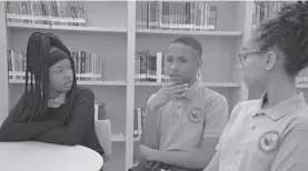  ?? KARL MERTON FERRON/BALTIMORE SUN ?? From left, Makenzie Peoples, 13, Nazaiah Johnson, 13, and Saniya Abrims, 12, discuss the Ingenuity Project, which is expanding to James McHenry Elementary/Middle School.