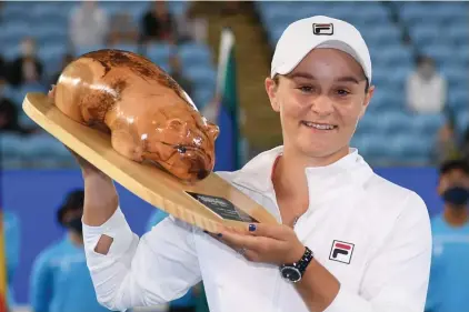  ??  ?? Australia's Ash Party holds her trophy after defeating Spain's Garbine Muguruza in the final of the Yarra Valley Classic in Melbourne