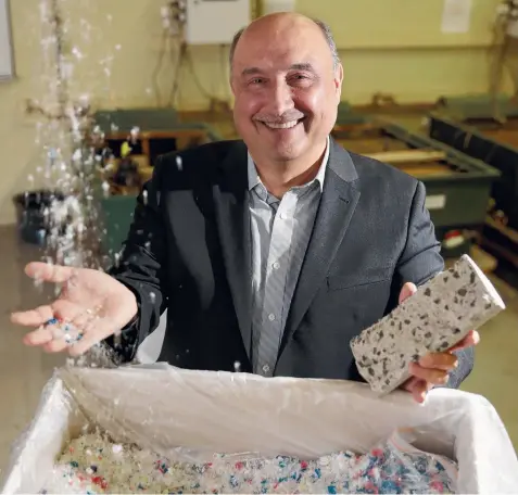  ?? Picture: ALISON WYND ?? PLASTIC FANTASTIC: Deakin University’s Dr Riyadh Al-Ameri with some of the dialysis waste, which has the potential to reduce water absorption in concrete by 30 per cent.