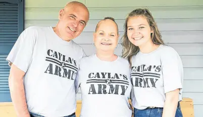  ?? COREY KATZ PHOTOGRAPH­Y ?? Tim, Cayla and Haley Toomey sport their Cayla’s Army shirts at home in Glace Bay, N.S.