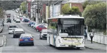  ?? PHOTO: GREGOR RICHARDSON ?? On the move . . . The new number 15 Ridge Runner bus, in Dundas St, North Dunedin, this week.