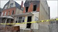  ??  ?? A man was taken to the hospital after a fire burned through this abandoned home on Monmouth Place.