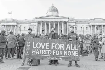  ?? Joel Ford / AFP / Getty Images ?? Members of the Muslim group Al Islam stand in solidarity with the victims of Wednesday’s terror attack at the British Parliament and Westminste­r Bridge in which five people were killed, including the assailant.