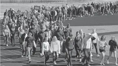  ?? Christophe­r Millette/Erie Times-News via AP ?? ■ Fairview Middle and High School students take part in a national school walkout event to protest gun violence and honor shooting victims at Fairview High School on Friday in Fairview Township, Erie County, Pa.