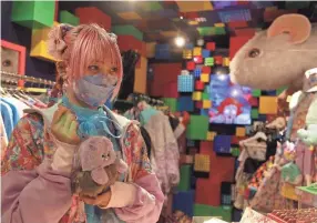  ?? YURI KAGEYAMA/AP ?? Sales clerk Emiry works at the 6%DOKIDOKI store in the heart of Tokyo’s Harajuku district on Oct. 22. Filled with pink, fuzzy and cuddly bears, the tiny store is bursting with “kawaii,” the Japanese term for cuteness.