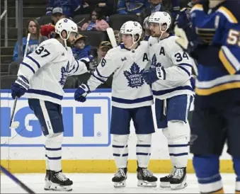  ?? Michael Thomas/Associated Press ?? The Maple Leafs’ Timothy Liljegren, Mitchell Marner and Auston Matthews celebrate after scoring a goal during the second period Monday in St. Louis.