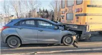 ?? ALISON JENKINS/JOURNALPIO­NEER ?? A small car was damaged with the driver struck the back of a school bus Wednesday morning. The children were unhurt and the driver sustained minor injuries.