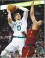  ?? Associated Press photo ?? Boston Celtics forward Jayson Tatum goes to the hoop against Cleveland Cavaliers guard Rodney Hood during the second half of Game 1 of the NBA basketball Eastern Conference Finals, Sunday in Boston.