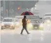  ?? Jerry Lara/staff file photo ?? A pedestrian crosses Fredericks­burg Road as rain pours on Oct. 5 in San Antonio. Similar weather is possible Monday.