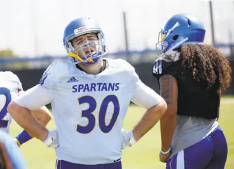  ?? Josie Lepe / Special to The Chronicle ?? San Jose State’s Jackson Burrill reacts after running drills in an August practice. Playing powerhouse teams can leave smaller programs beaten up physically.