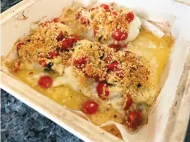  ?? GRETCHEN MCKAY/PITTSBURGH POST-GAZETTE/TNS ?? Baked cod is topped with lemon butter, garlicky tomatoes and a Parmesan-panko crust for a simple, but satisfying, supper.