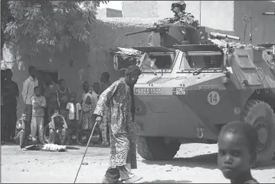  ??  ?? French soldiers patrol a street in Gao on Feb 28. France, which is battling Islamist militants in Mali, will not formally propose setting up a UN
peacekeepi­ng force to take over until at least April, the French UN ambassador said Wednesday. (AFP)