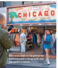  ??  ?? Kim was keen to be pictured walking past a shop with her daughter’s name