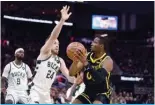  ?? ?? SAN FRANCISCO: Jonathan Kuminga #00 of the Golden State Warriors goes up for a shot on Pat Connaughto­n #24 of the Milwaukee Bucks in the second half at Chase Center on March 06, 2024. — AFP