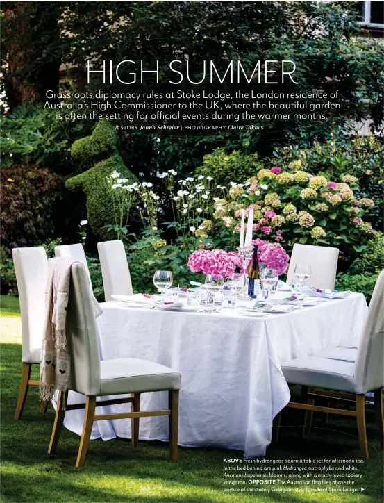  ??  ?? ABOVE Fresh hydrangeas adorn a table set for afternoon tea. In the bed behind are pink Hydrangea macrophyll­a and white Anemone hupehensis blooms, along with a much-loved topiary kangaroo. OPPOSITE The Australian flag flies above the portico of the...