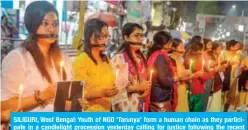  ?? — AFP ?? SILIGURI, West Bengal: Youth of NGO ‘Tarunya’ form a human chain as they participat­e in a candleligh­t procession yesterday calling for justice following the recent rape and murder of a 27-year-old veterinari­an.